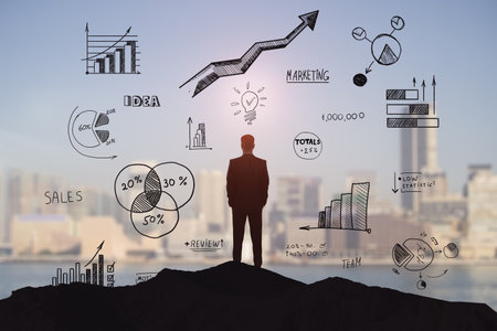 Silhouette of a businessman evaluating financial statistics against a city backdrop. Idea and team conceptの写真素材