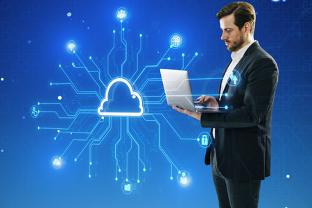 Attractive young European businessman using laptop with creative digital circuit cloud on blue...