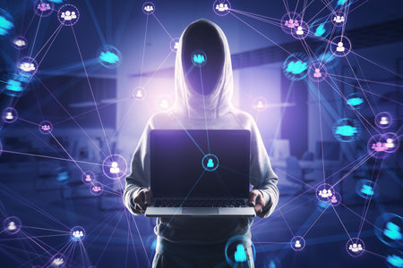 Hacker in hoodie holding laptop with connected digital people team icons on dark blurry purple...