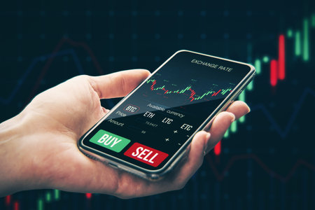 Close up of female hand holding smartphone with glowing forex chart on dark background. Trade, stock...
