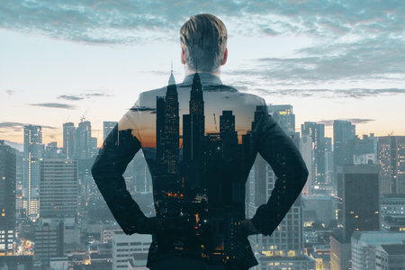 Back view of young European man standing on night city background. Success, future and tomorrow concept. Double exposureの写真素材
