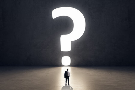 Back view of tiny businessman in concrete room interior with huge bright question mark opening. Doubt and choice conceptの写真素材