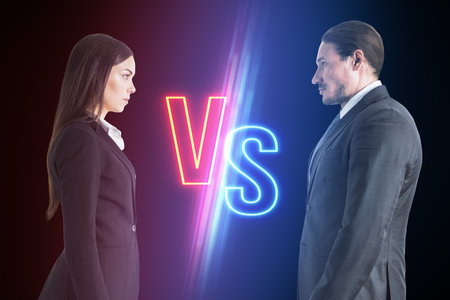 Two business professionals face off under a neon 'VS' sign, illustrating corporate rivalryの写真素材