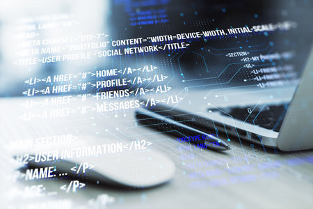 Image showing a modern laptop with digital code overlay depicting software development concepts in the foregroundの写真素材