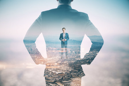 A conceptual image of a businessman silhouette with an overlay of cityscape representing ambition...