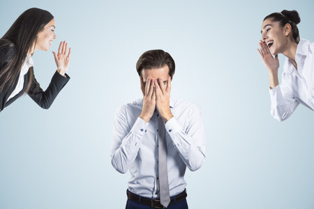 Young businessman dealing with bullying at workplace on white background. Attractive european businessmen portraitの写真素材