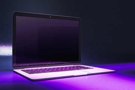 Close up of creative neon purple light gaming notebook with mock up place. 3D Renderingの写真素材