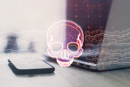 Close up of laptop and smartphone on desk with creative skull and circuit hologram on blurry background. Malware and ransomware concept. Double exposureの写真素材