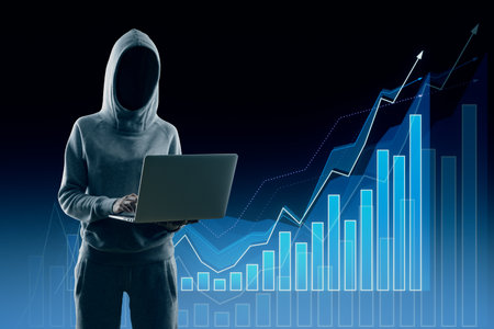 Hacker in hoodie standing and using laptop with creative growing forex chart on dark background....