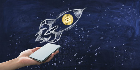 Hand holding a smartphone with a Bitcoin symbol launching out, illustrated on a chalkboard...