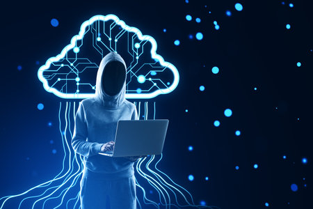 A person in a hoodie using a laptop with a glowing digital brain concept on a dark blue backgroundの写真素材