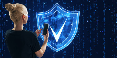 Woman holding a smartphone with a digital shield and checkmark icon on a binary code background....