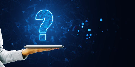 A digital question mark floating above a tablet held by a hand on a dark blue background. Concept of technology and curiosityの写真素材