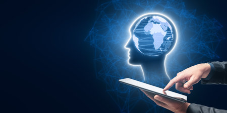 Close up of man hand pointing at phone with blue world map inside polygonal head outline hologram on...