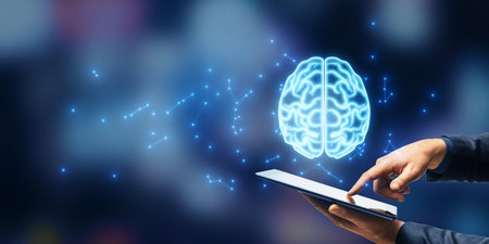 A digital brain hologram above a tablet being touched by a person's hand, on a blurred background. Concept of artificial intelligence and technologyの写真素材