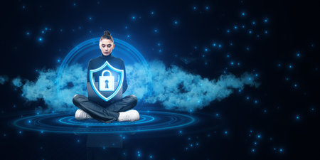 Attractive young woman sitting on floor with crossed legs and using laptop with glowing padlock and...