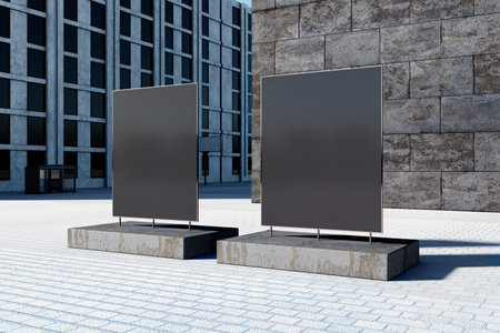 Two blank outdoor billboards stand on a city street, positioned against a modern building facade....