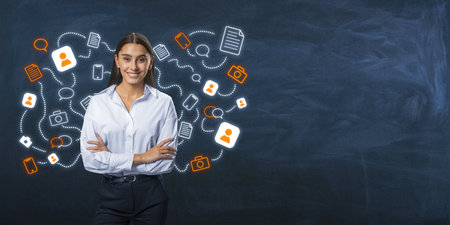 Young woman stands with arms crossed, surrounded by social media icons on a chalkboard background. Concept of online communication and networkingの写真素材