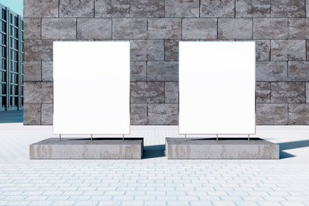 Two blank rectangular billboards stand on a city street with a stone wall background, perfect for design or advertising mockups. 3D Renderingの写真素材
