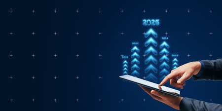 Hands using a digital tablet with glowing arrows pointing up, signifying business growth and goals for 2025 on a dark blue background. Concept of future targets and achievementsの写真素材