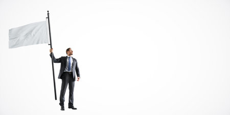 Businessman in a suit holding a large white flagpole, standing on a light white background. Concept...