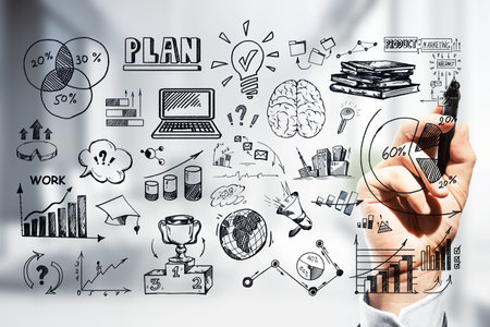 Hand drawing various business planning and strategy elements on a glass screen, with a blurred background. Concept of market research and corporate strategyの写真素材