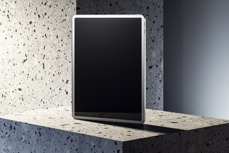 Blank tablet screen mockup on a stone base. Modern design with a dark background and spotlight. Concept of technology and digital presentation. 3D Renderingの写真素材