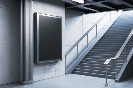 Blank advertising board on a wall beside a modern staircase in a subway station. Indoor, architectural setting with a sleek, contemporary design. 3D Rendering.の写真素材