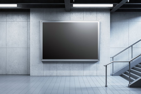 Blank digital billboard on a gray wall in a modern subway station near metal stairs. Concept of advertising mockup. 3D Renderingの写真素材