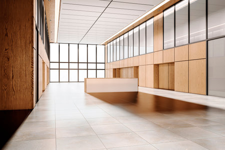 Modern and spacious company lobby with a reception desk, wooden panels, and large windows. Beige and white color scheme, city view background. 3D Rendering.の写真素材