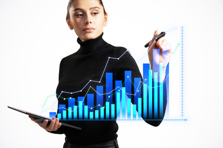 Businesswoman analyzing data on virtual screen while holding a tablet. White background. Concept of business analytics and technologyの写真素材