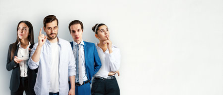 Group of businesspeople standing in an office room against a white wall background, showcasing the concept of teamwork and collaborationの写真素材