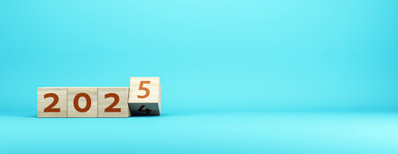 A creative design featuring wooden blocks showing the year 2025 on a smooth blue background. Concept of future goals. 3D Renderingの写真素材
