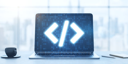 Close up of laptop computer with glowing programming code on blurry office desk with coffee cup and...