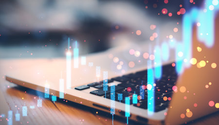 Close up of laptop on desk with glowing blurry candlestick forex chart on blurry background....