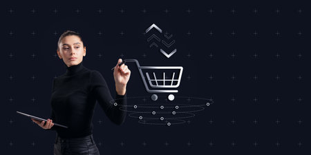 Attractive thoughtful young caucasian woman with tablet using creative shopping cart icon on dark background with mock up place. E-commerce and advertising design conceptの写真素材