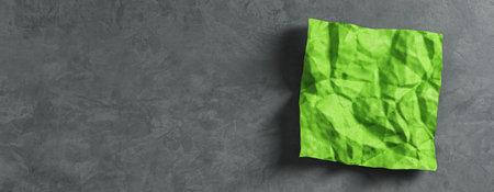 Close up of wrinkled green piece of paper on wide gray desk background with mock up place. Supplies, stationery, school, work and education concept. 3D Renderingの写真素材