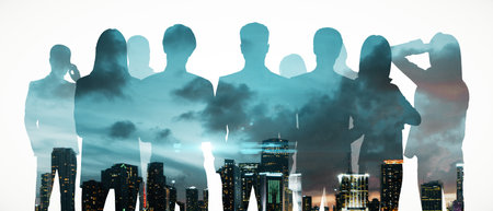 Crowd of businesspeople silhouettes on white night city background. Teamwork, leadership, success and partners concept. Double exposureの写真素材