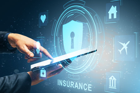 Close up of businessman hand using cellphone with creative life insurance hologram with padlock and other icons on blue backgroundの写真素材