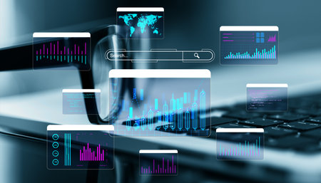Floating digital charts and data analysis graphics over a laptop keyboard. Futuristic design on blue...