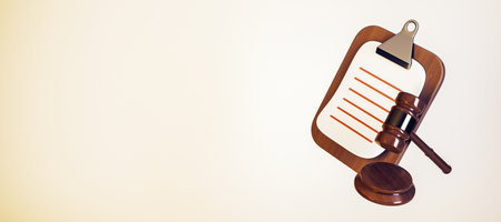 Wooden gavel and clipboard with blank paper on a light yellow background, representing legal...