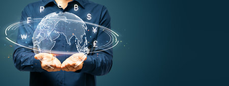 Businessman holding a digital globe with various currency symbols floating around. Futuristic style...