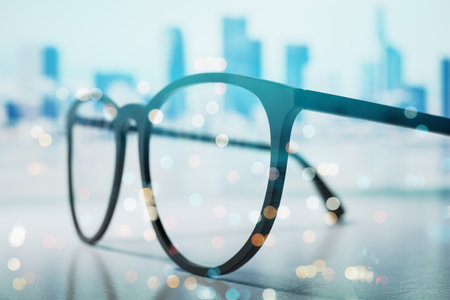 Eyeglasses close-up on a desk, blurred city background with bokeh lights, emphasizing a business and focus concept, modern workspace vibe. 3D Rendering.の写真素材