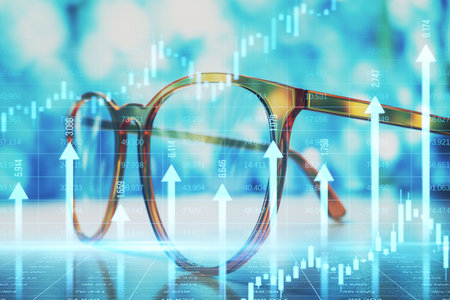 Closeup of glasses on desk with upward financial charts, blue blurred background, symbolizing market growth, success, and progressの写真素材