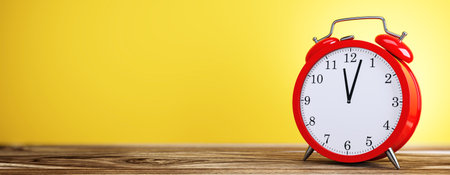Red alarm clock with white dial on wooden surface, vibrant yellow background, concept of time management, business, and organization. 3D Rendering.の写真素材