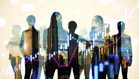 Silhouettes of businesspeople overlaid on a cityscape with financial charts, emphasizing collaboration, growth, and corporate success conceptsの写真素材