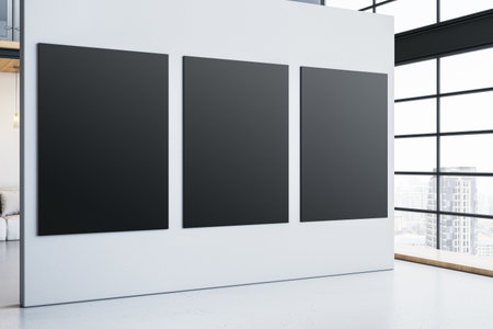 Three black canvases on a white wall in a spacious modern interior with large glass windows, city...