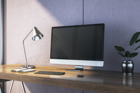 Modern desk with computer monitor, lamp, keyboard, and potted plant on wooden surface, concrete wall in background, concept of workspace. 3D Rendering.の写真素材