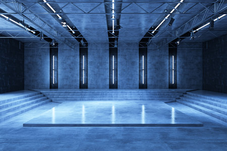 Contemporary empty room with concrete walls, steps, and a stage, illuminated by blue lights. Modern interior design for events or presentations. 3D Rendering.の写真素材
