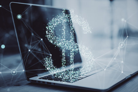 Laptop with glowing dollar sign hologram overlay, digital connections in background, on desk. Concept of finance, technology, and innovationの写真素材